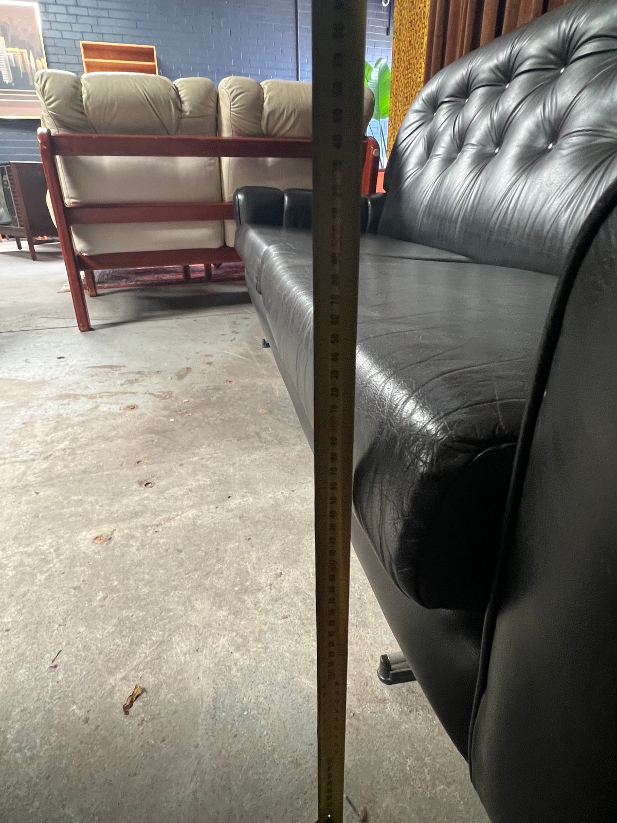 Black Button-Tufted Three-Seater Lounge with Chrome Legs