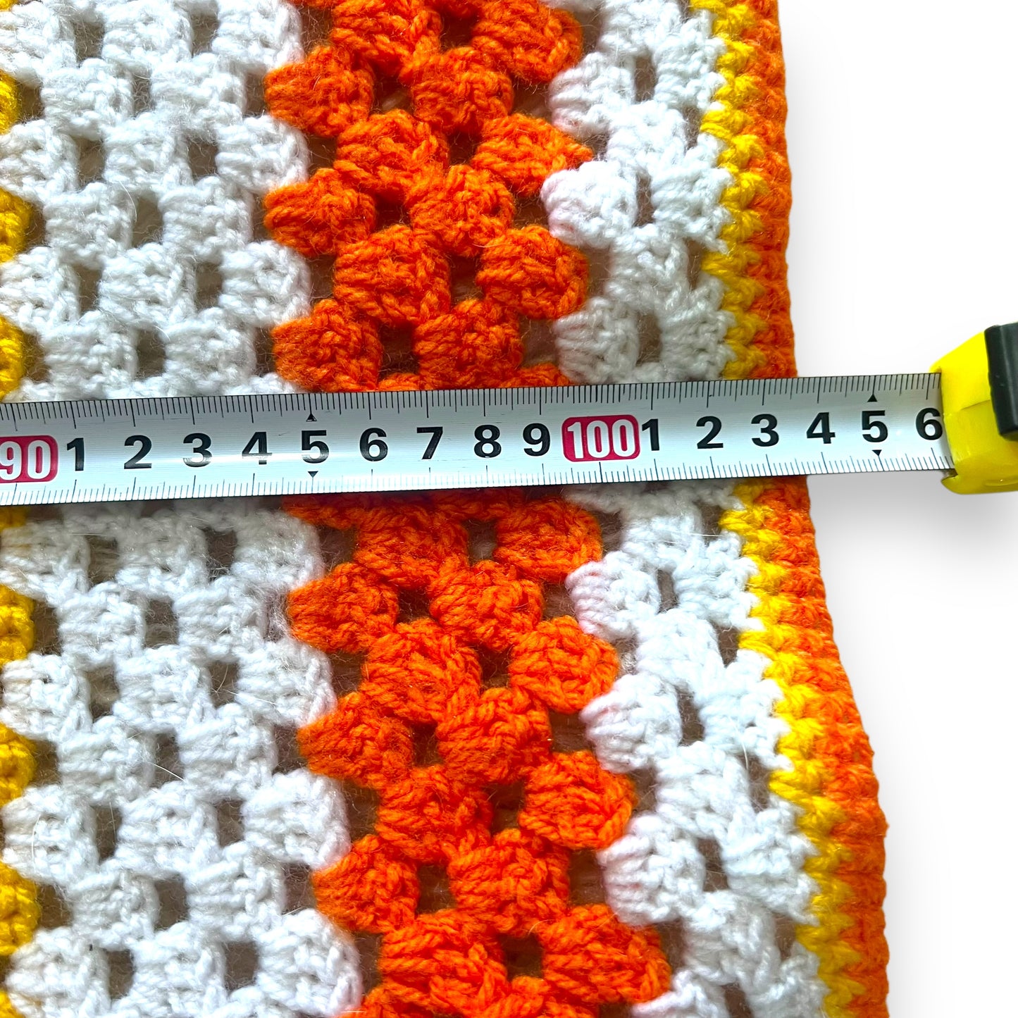 Orange, yellow and white crochet knit blanket