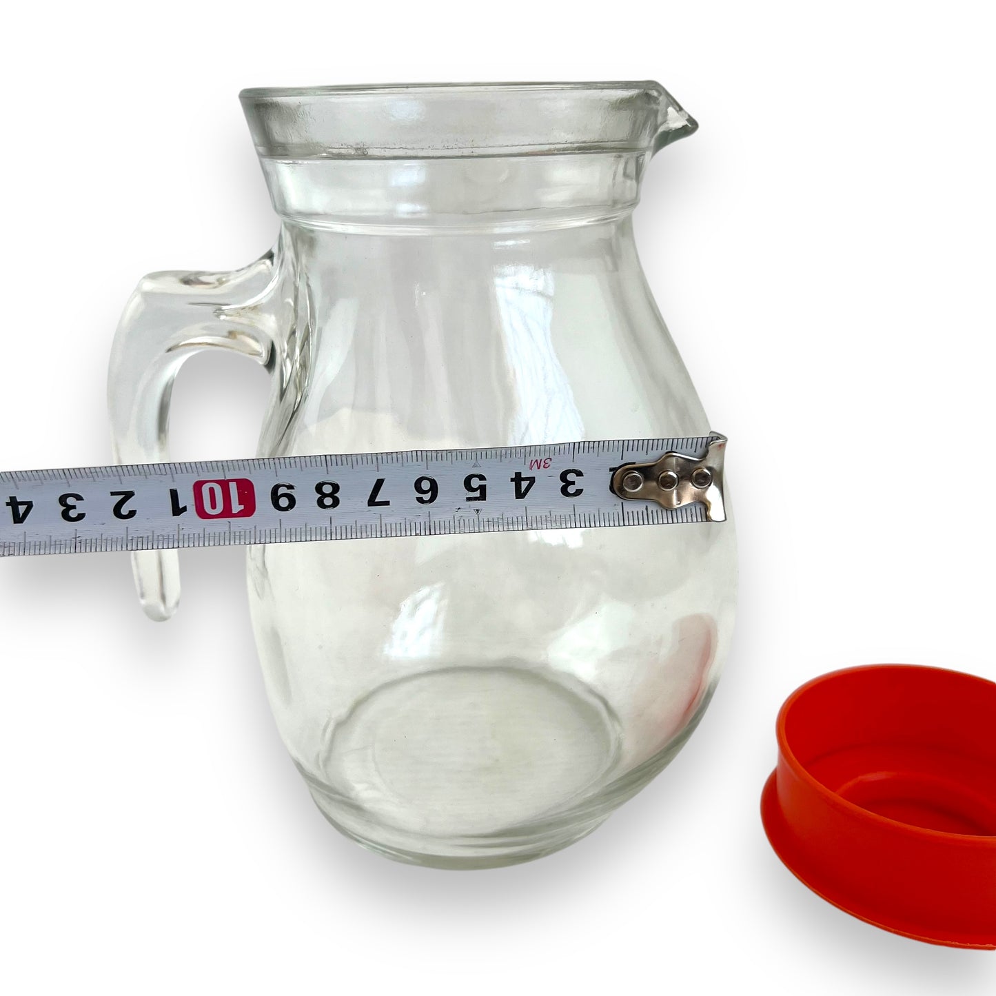 Clear jug with red plastic lid