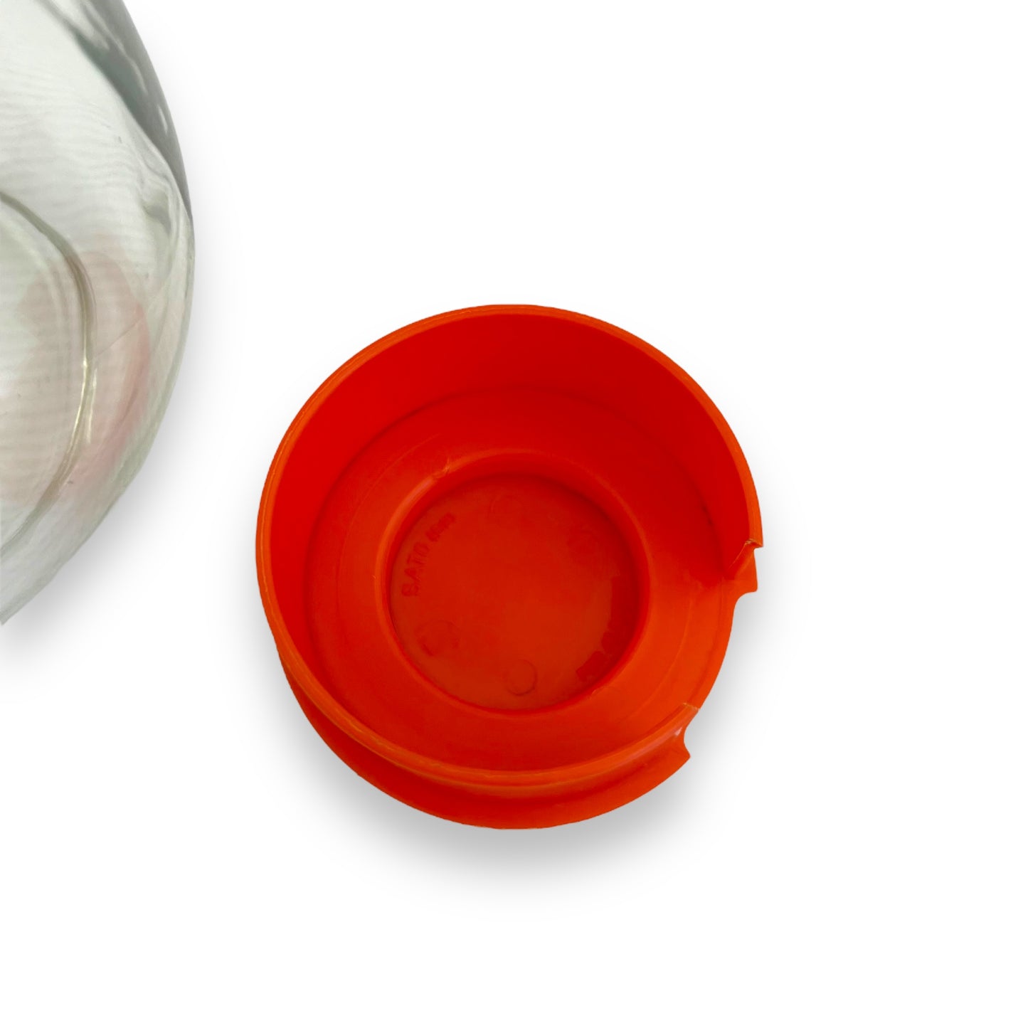 Clear jug with red plastic lid