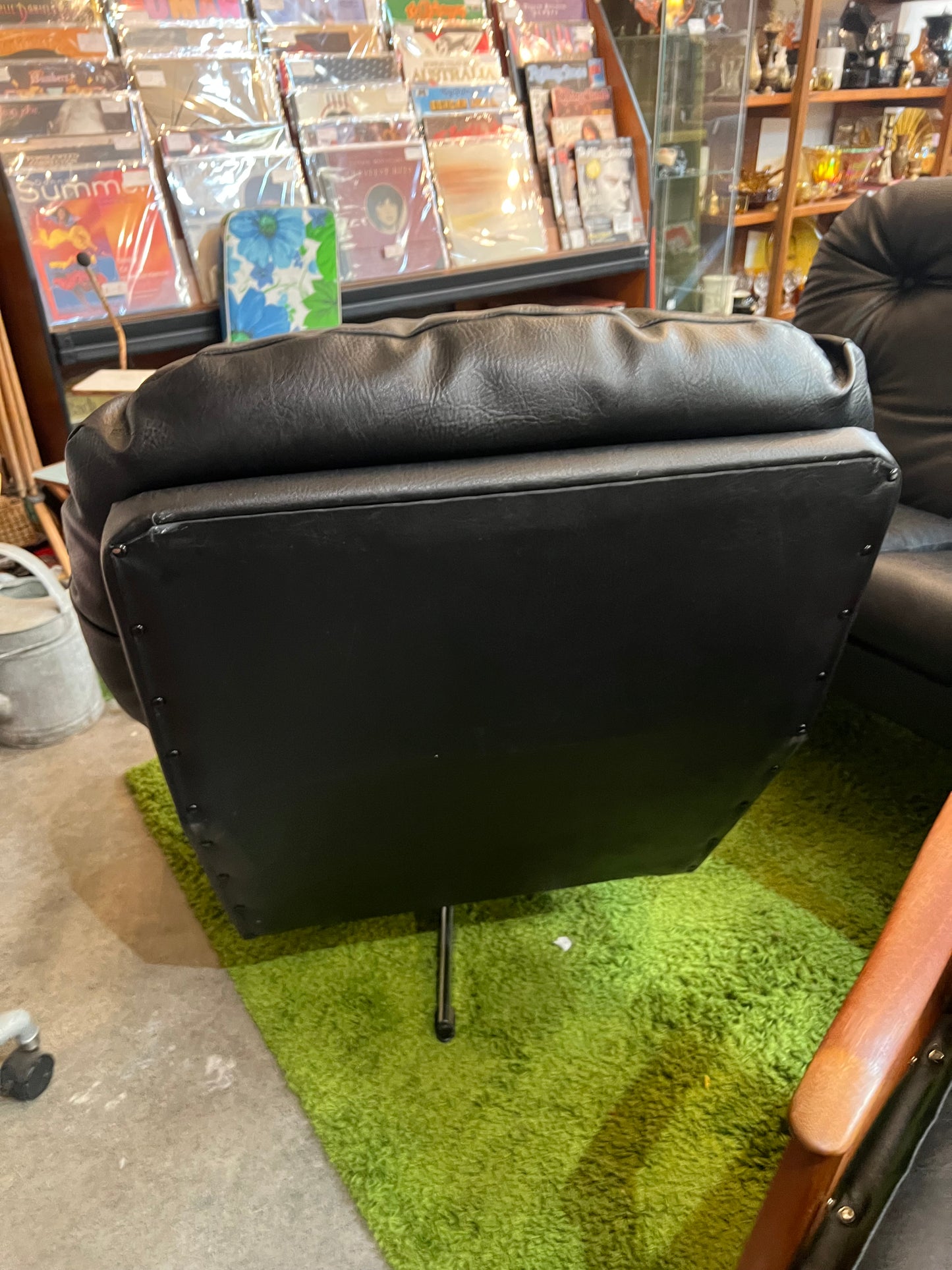 1. Black Vinyl Swivel Armchair with Timber Arms