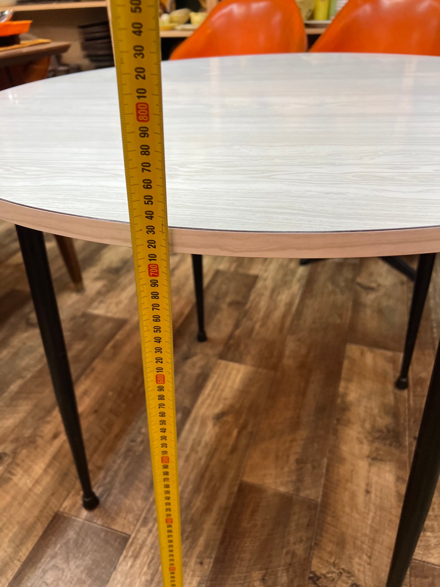 Namco Round Mid Century Dining Table with White Woodgrain Laminate Top and black steel legs