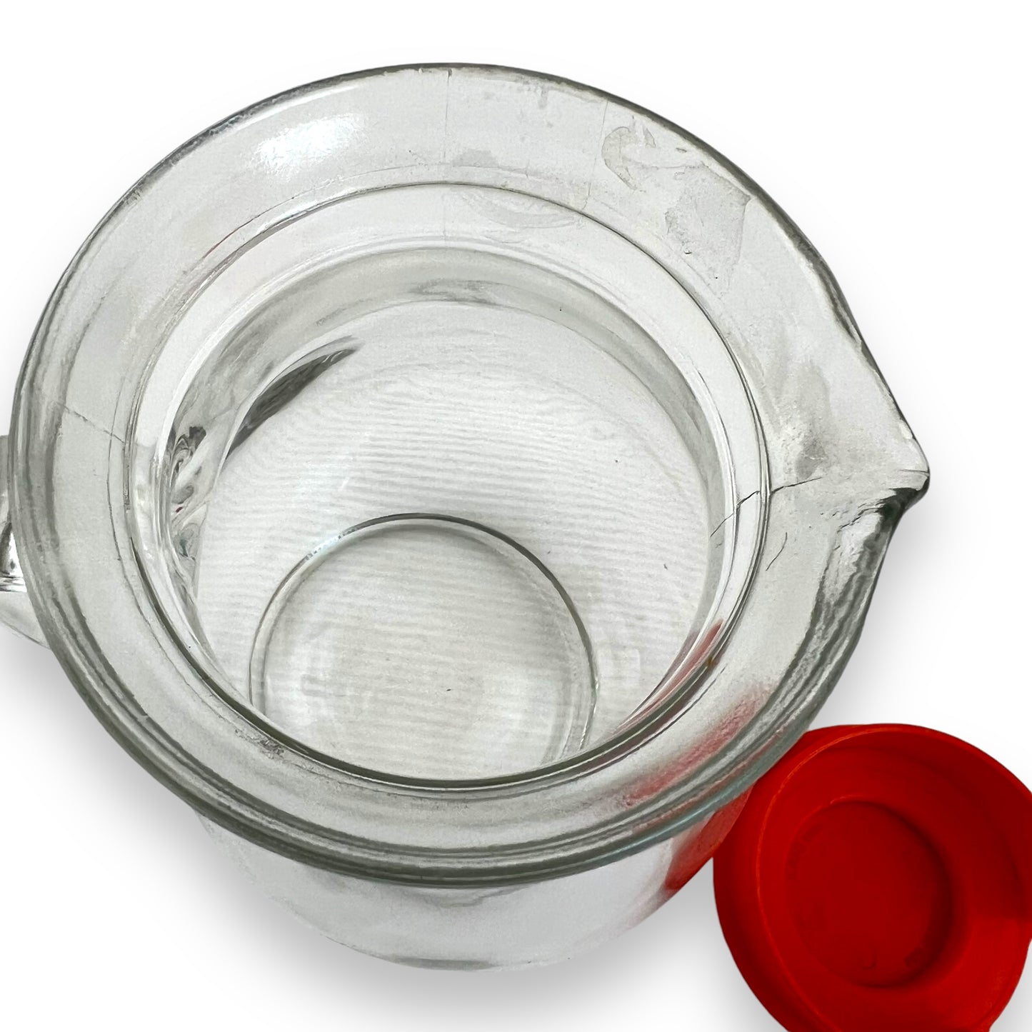 Clear jug with red plastic lid