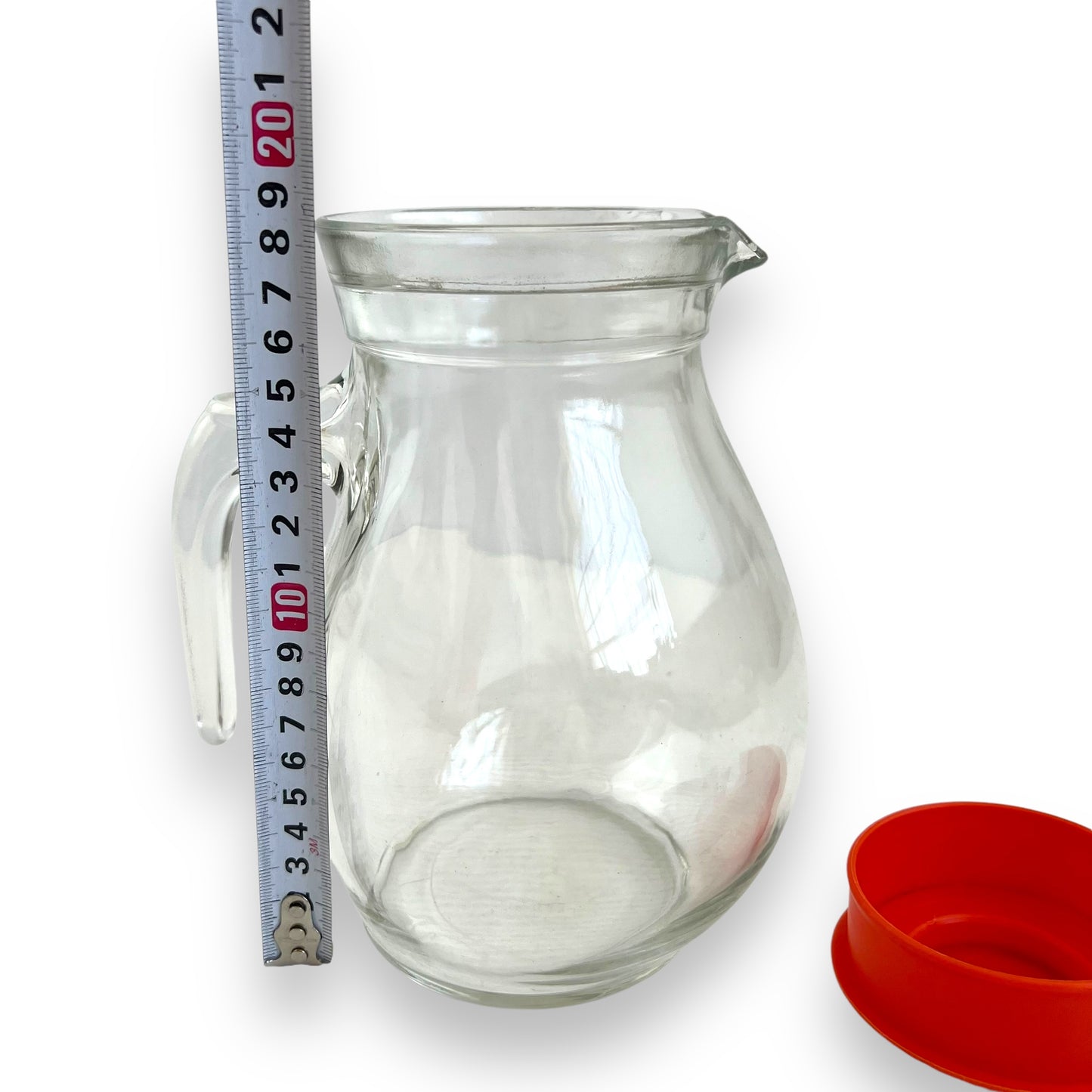 Clear jug with red plastic lid