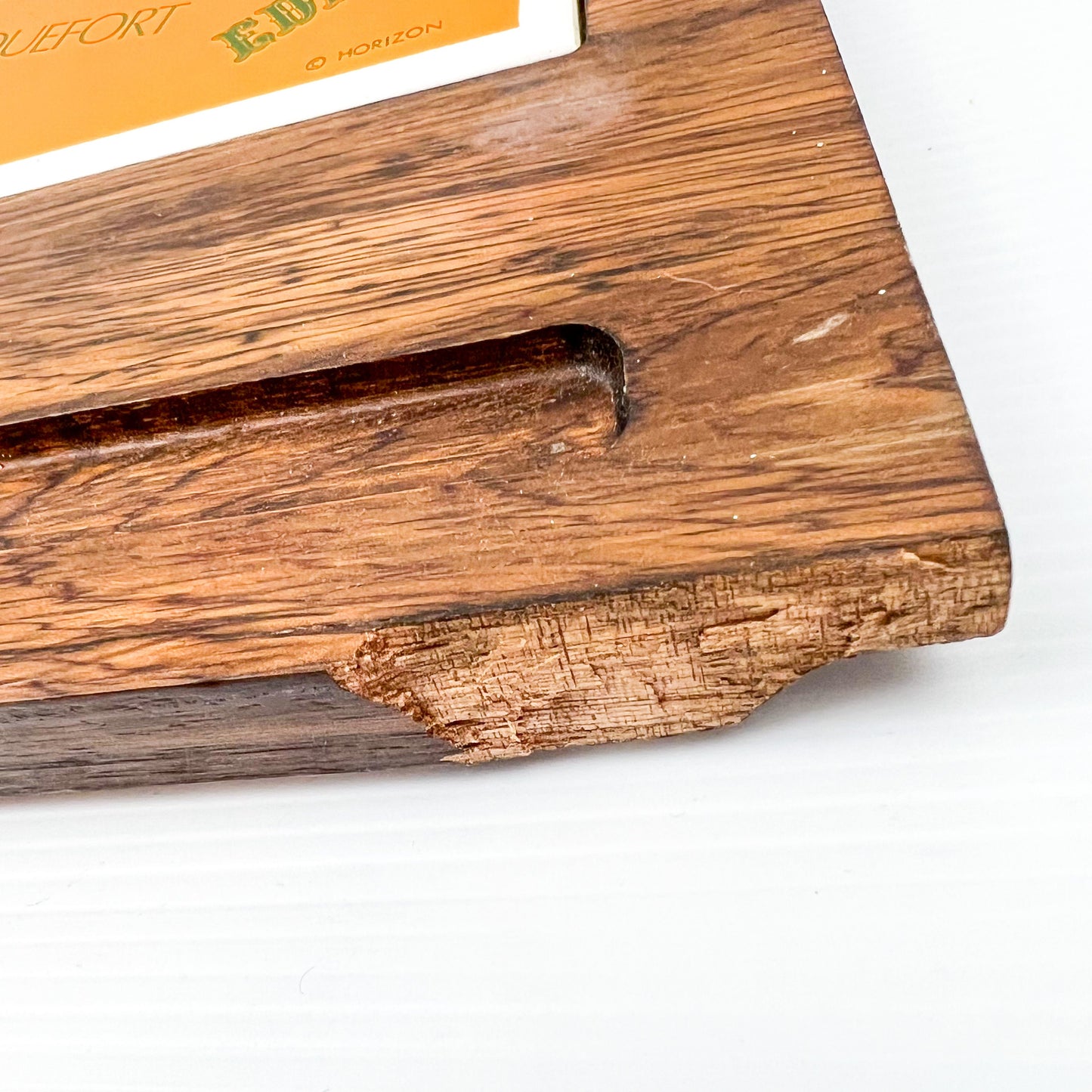 Wooden cheese board with cheese name tile and knife