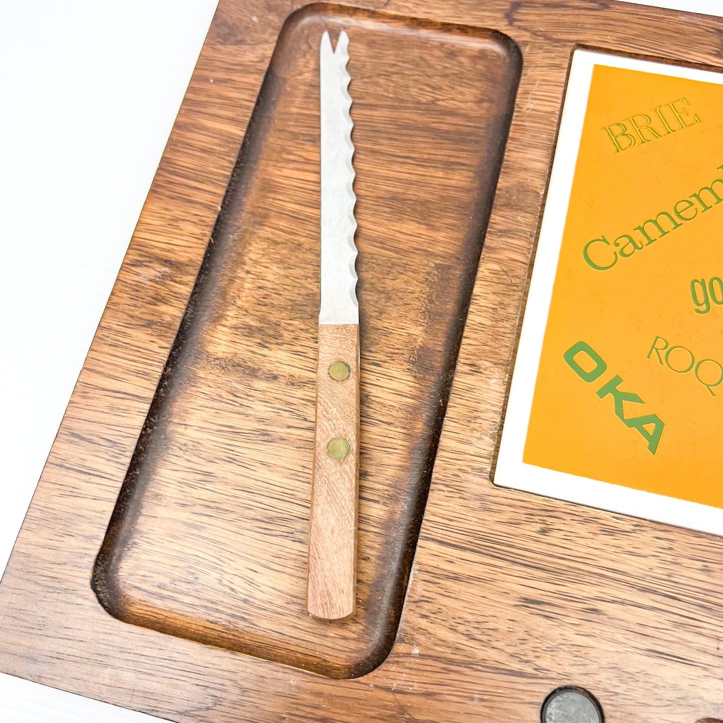 Wooden cheese board with cheese name tile and knife