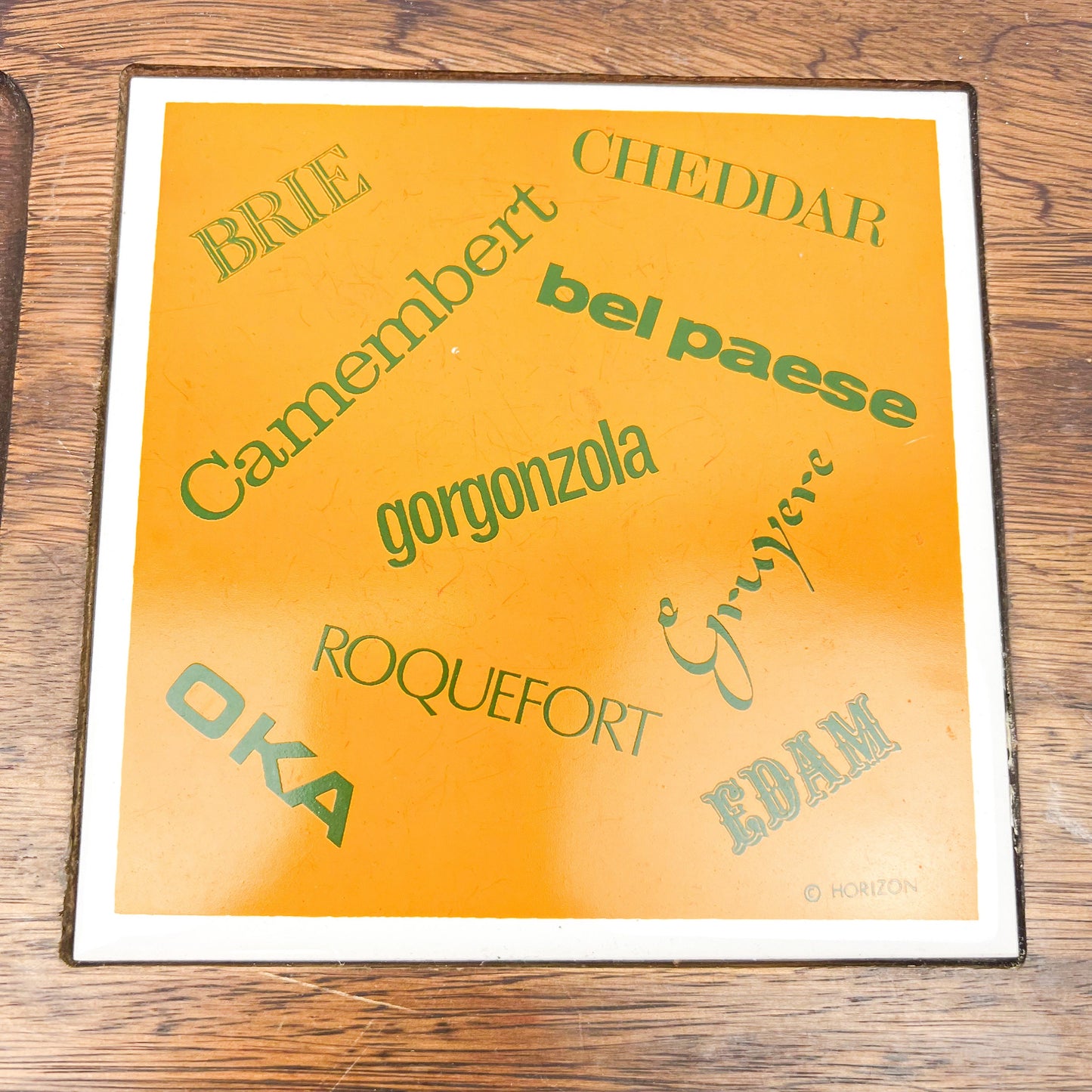 Wooden cheese board with cheese name tile and knife