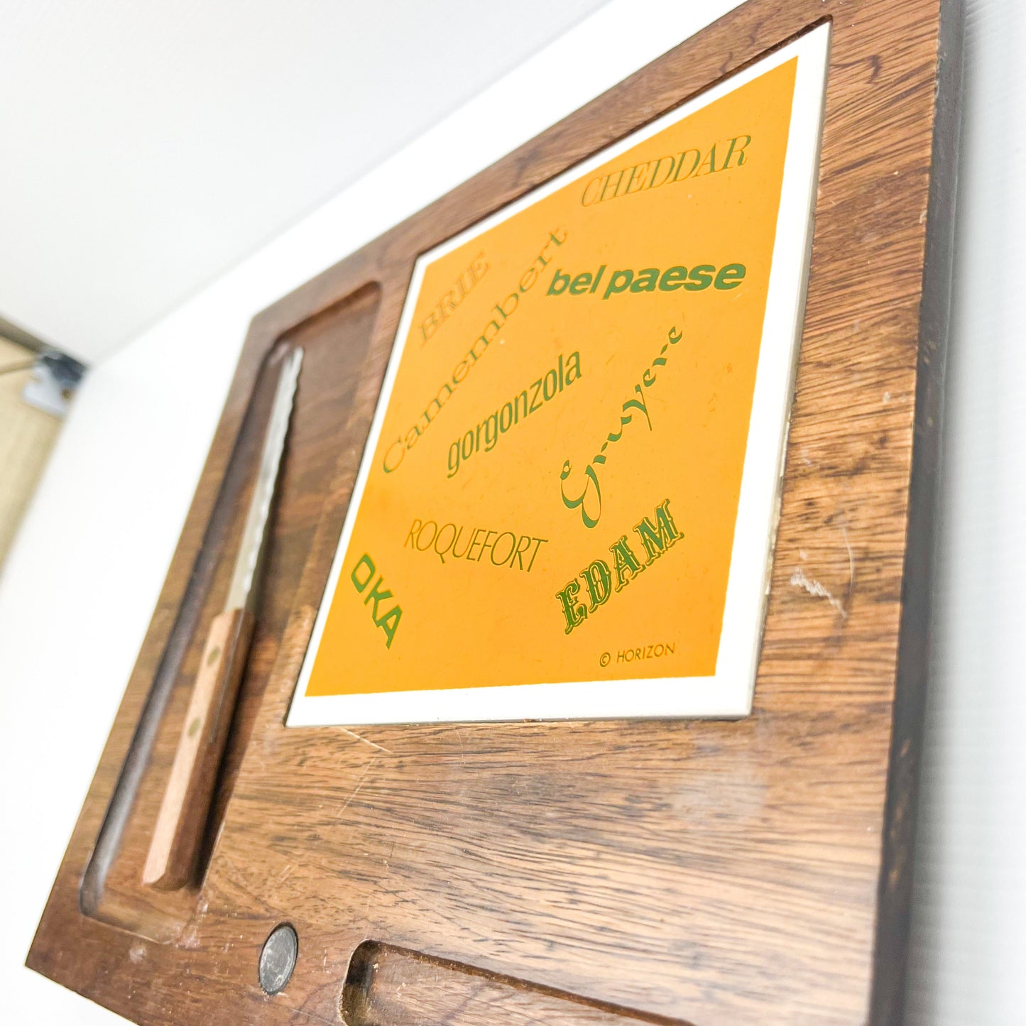 Wooden cheese board with cheese name tile and knife