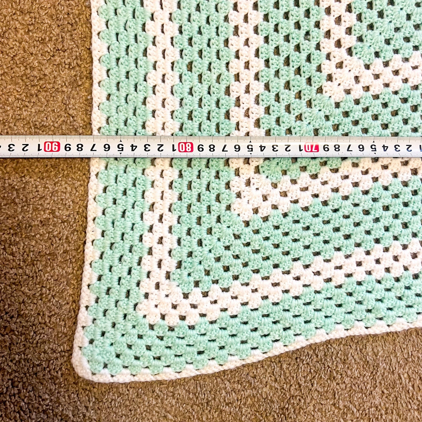 Aqua and white crochet knit blanket