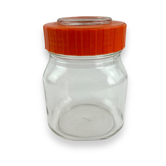 Clear glass jar orange lid