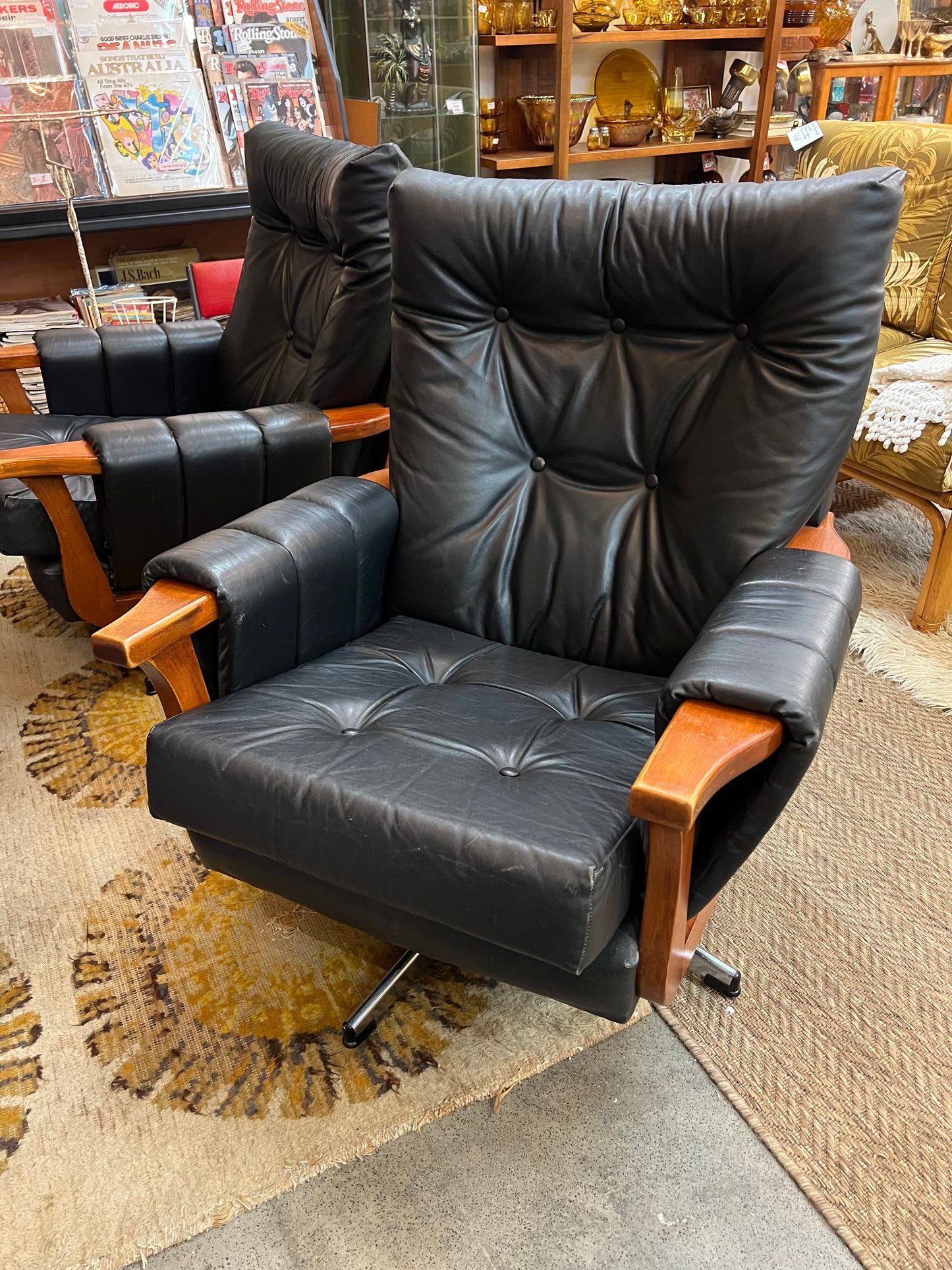 1. Mid-Century Black Leather Swivel Lounge Chair