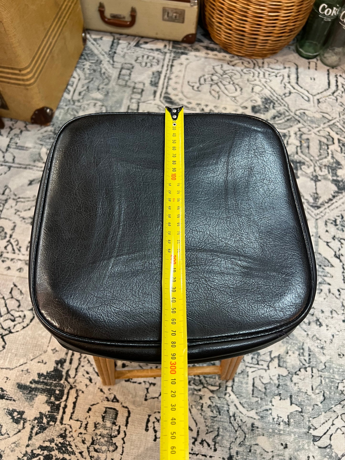 Wooden stool with black top