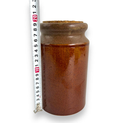 Brown pottery jar with cork lid