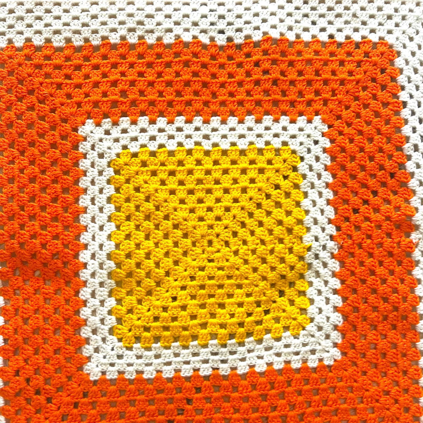 Orange, yellow and white crochet knit blanket