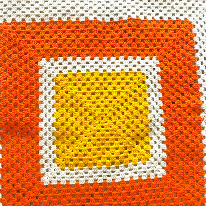 Orange, yellow and white crochet knit blanket