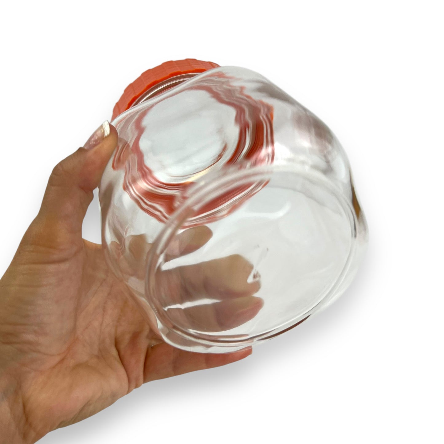 Clear glass jar orange lid