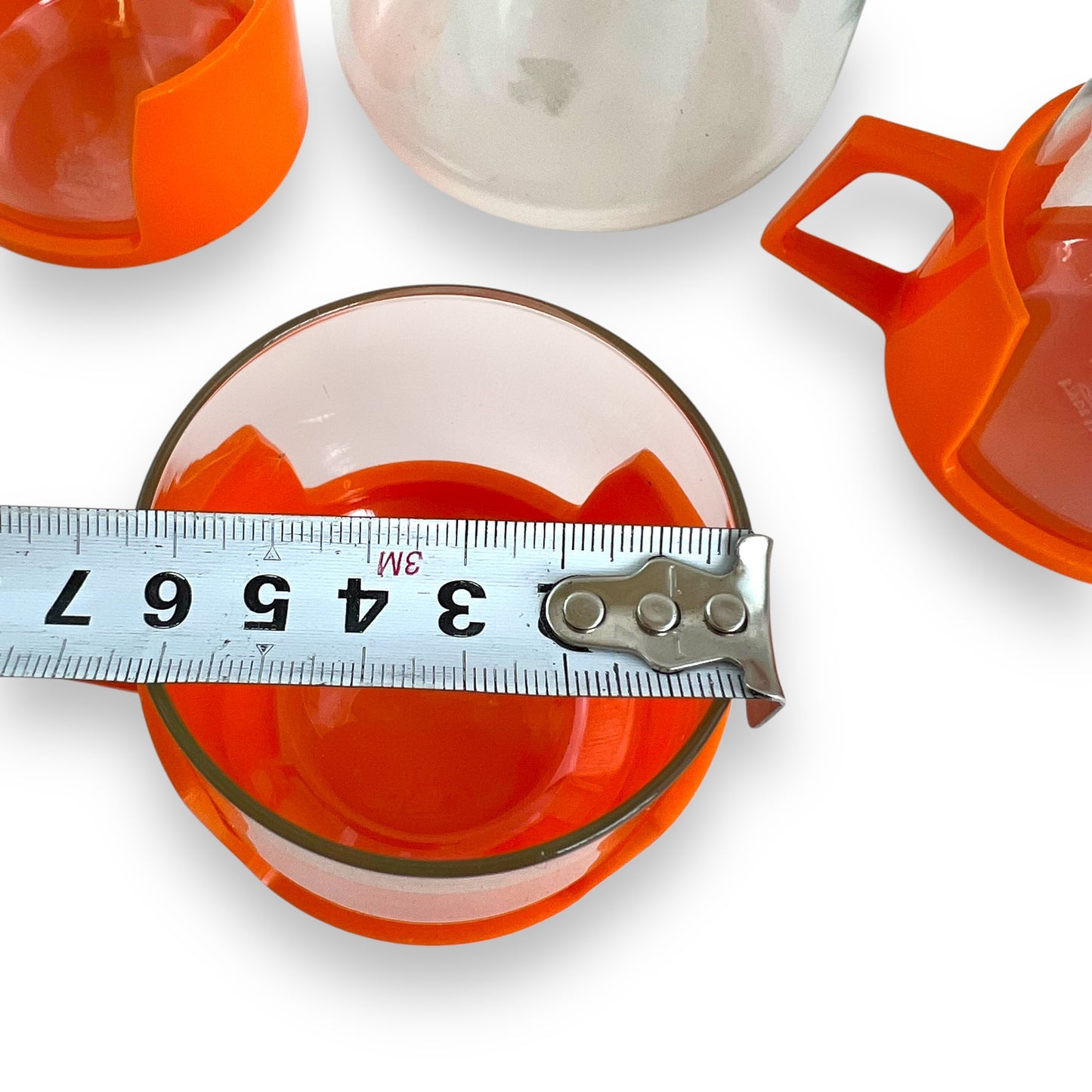 JAJ Pyrex Clear glass jug & 3 cups with orange plastic handles and lid.