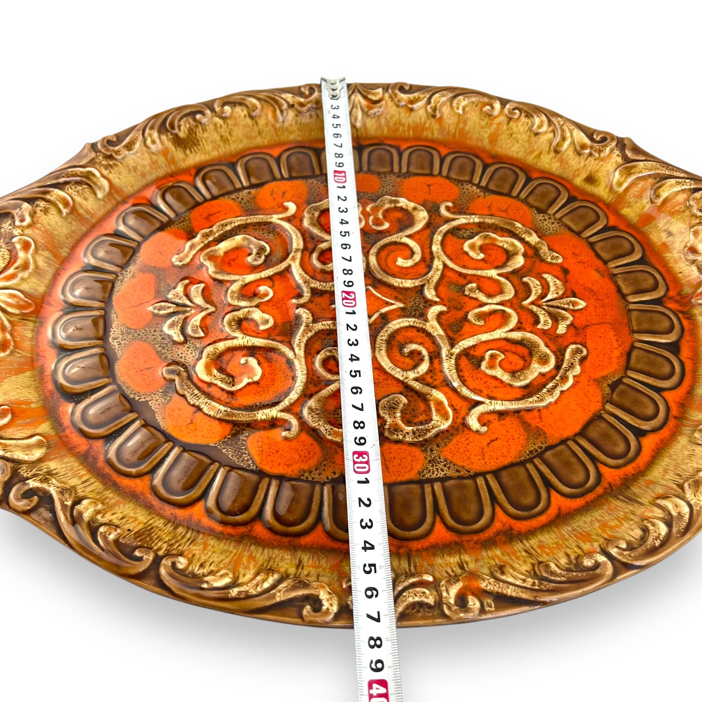 Large orange and brown ornate ceramic serving platter