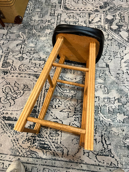 Wooden stool with black top
