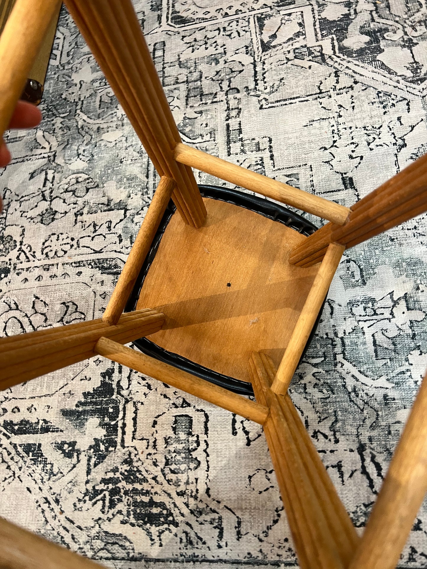 Wooden stool with black top