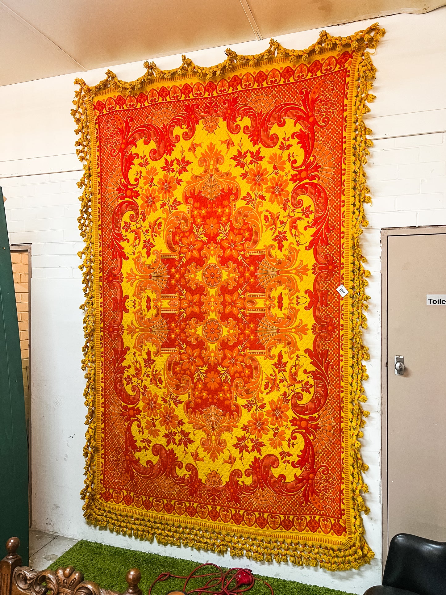 Large orange and yellow patterned wool rug