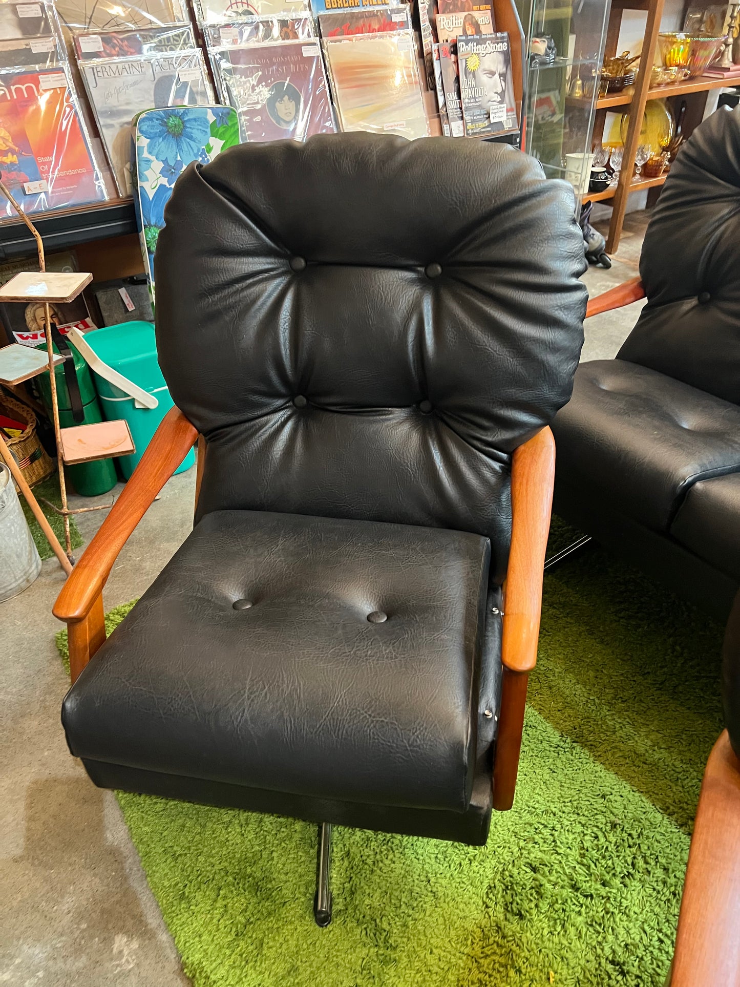 1. Black Vinyl Swivel Armchair with Timber Arms