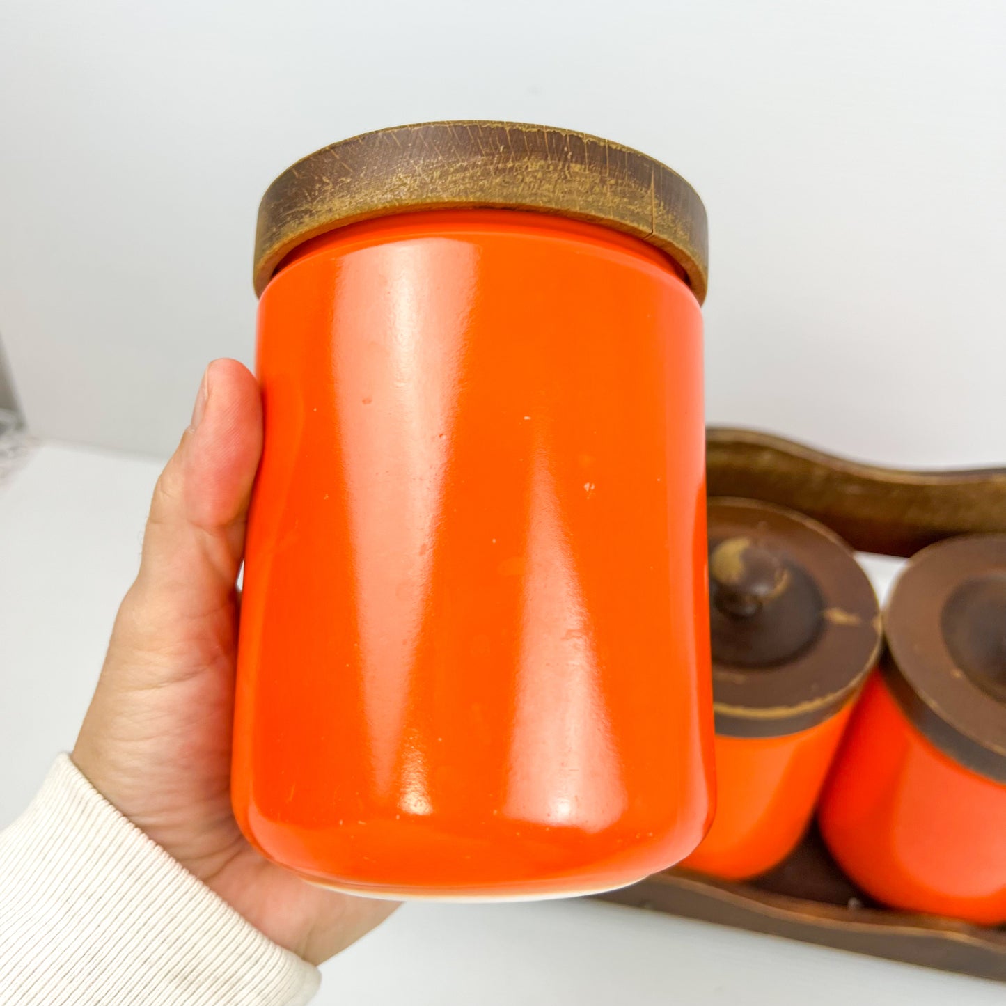 Orange Kitchen Storage Canister Jars with wooden lids and wooden hanging shelf