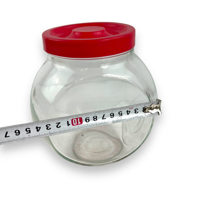 Red lid round glass storage jar