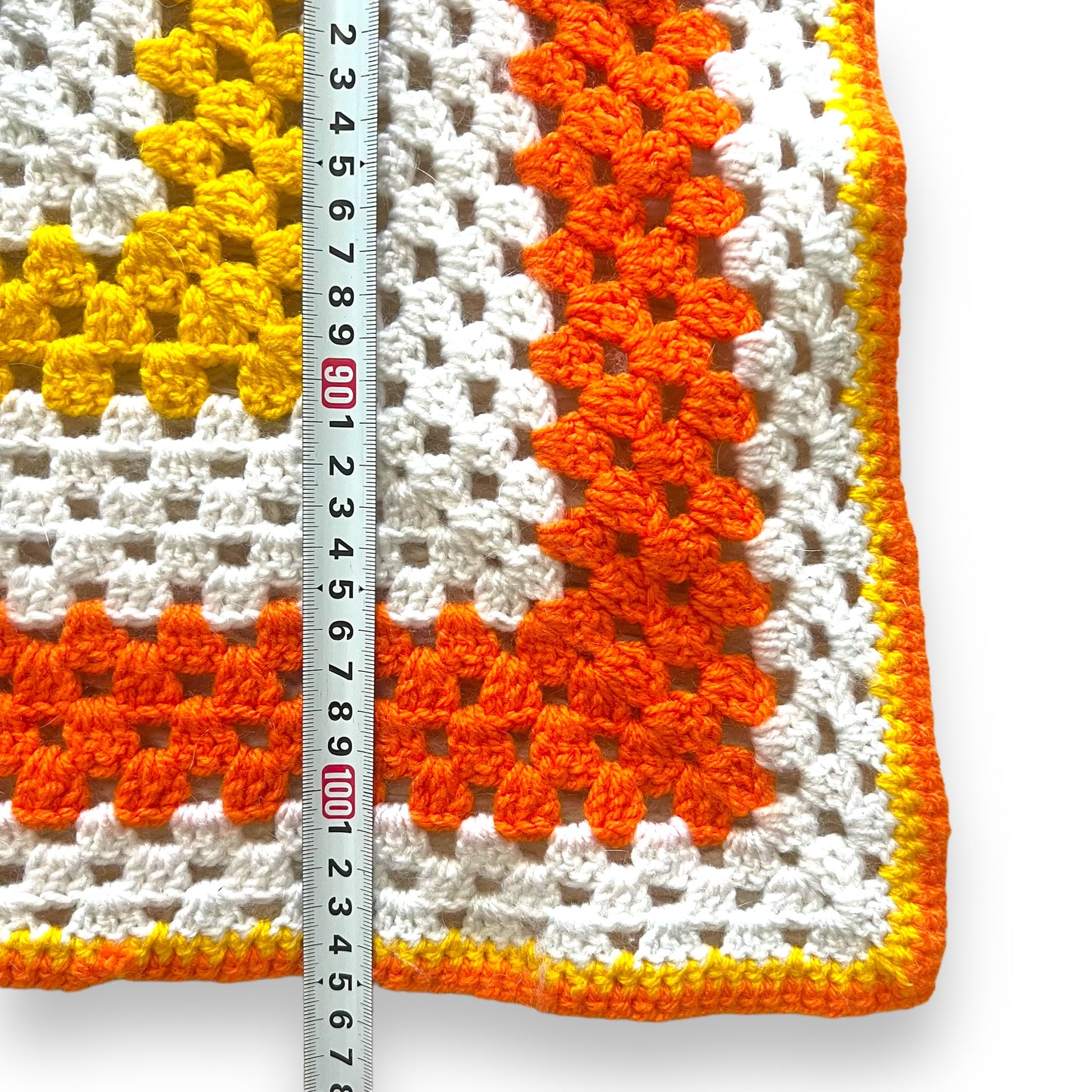 Orange, yellow and white crochet knit blanket