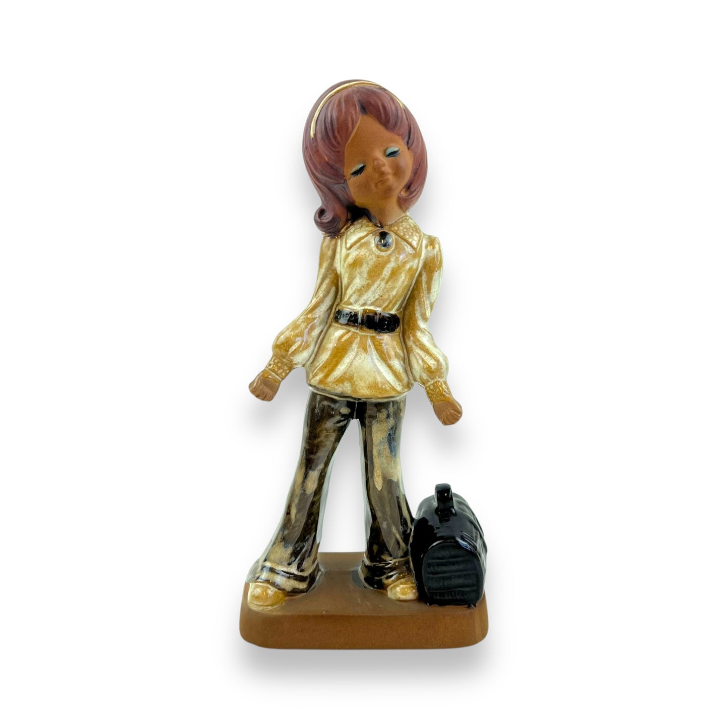 Girl with eyes closed statue and bag