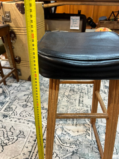 Wooden stool with black top