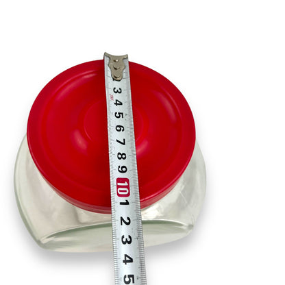 Red lid round glass storage jar