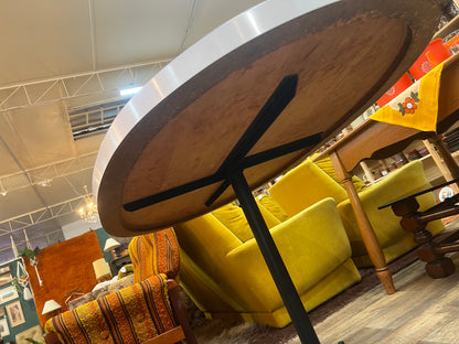 White oval dining table with black steel pedestal base