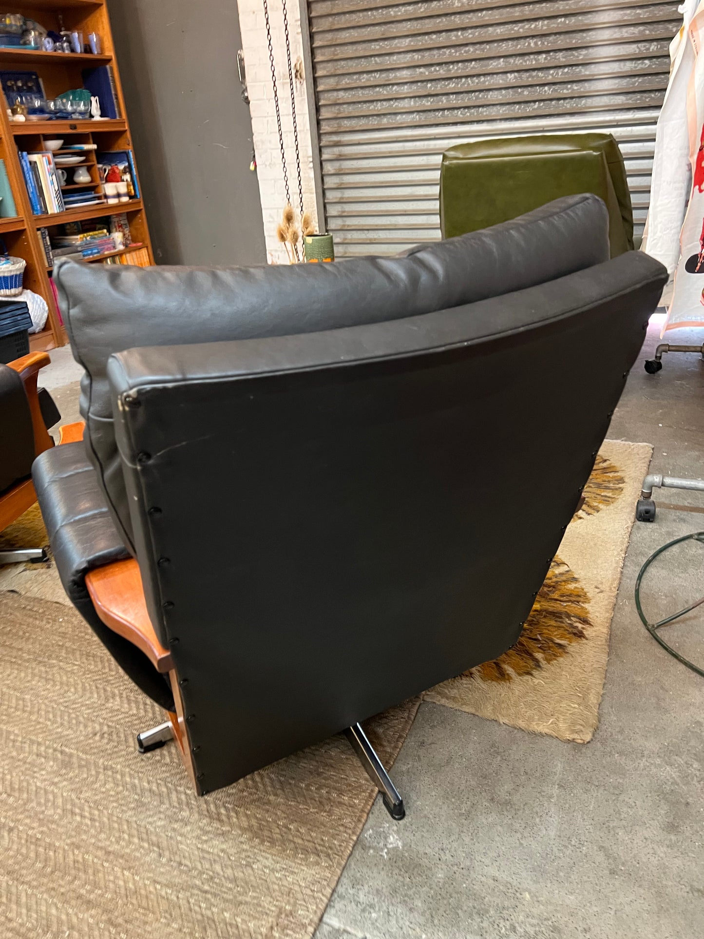 2. Mid-Century Black Leather Swivel Lounge Chair