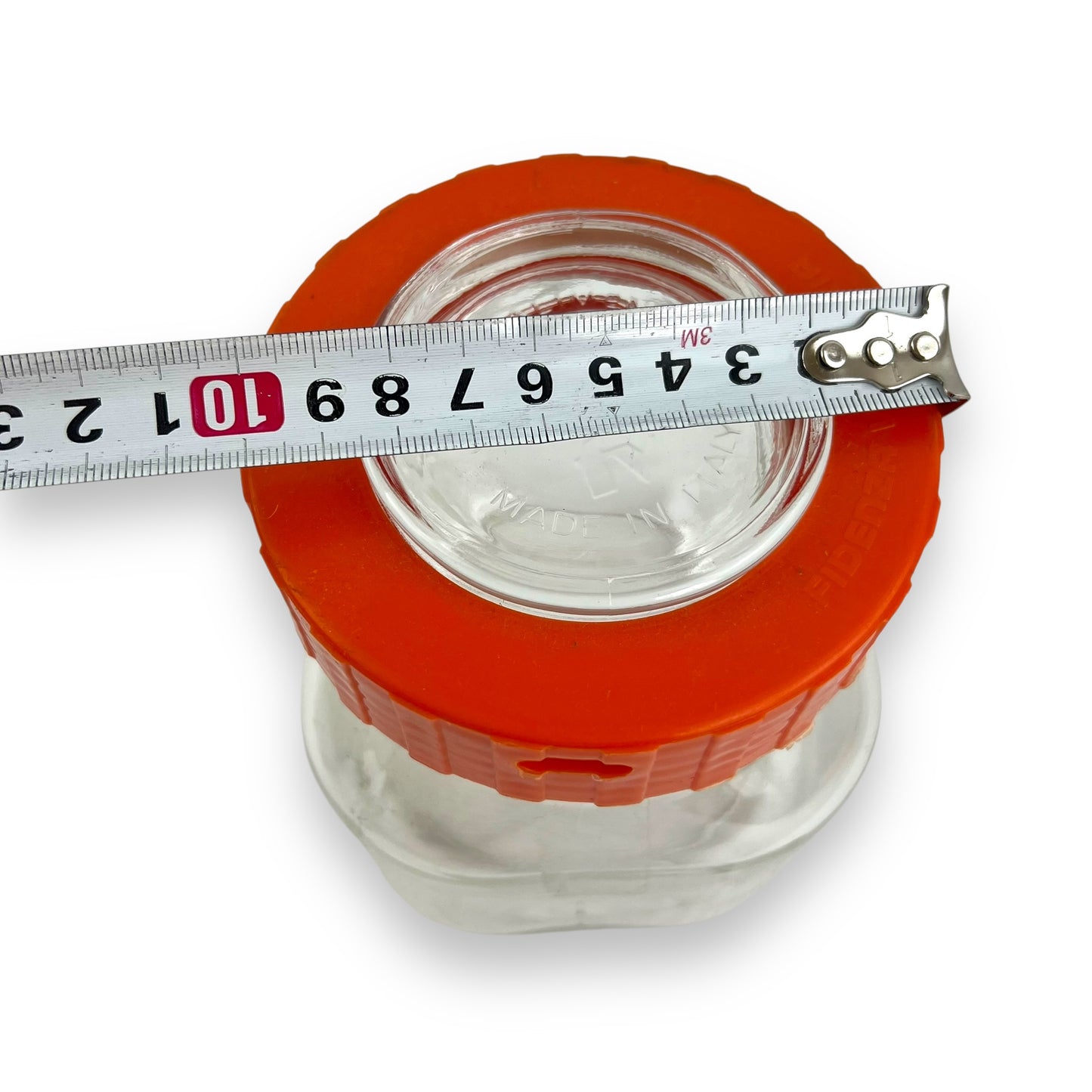 Clear glass jar orange lid