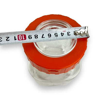 Clear glass jar orange lid