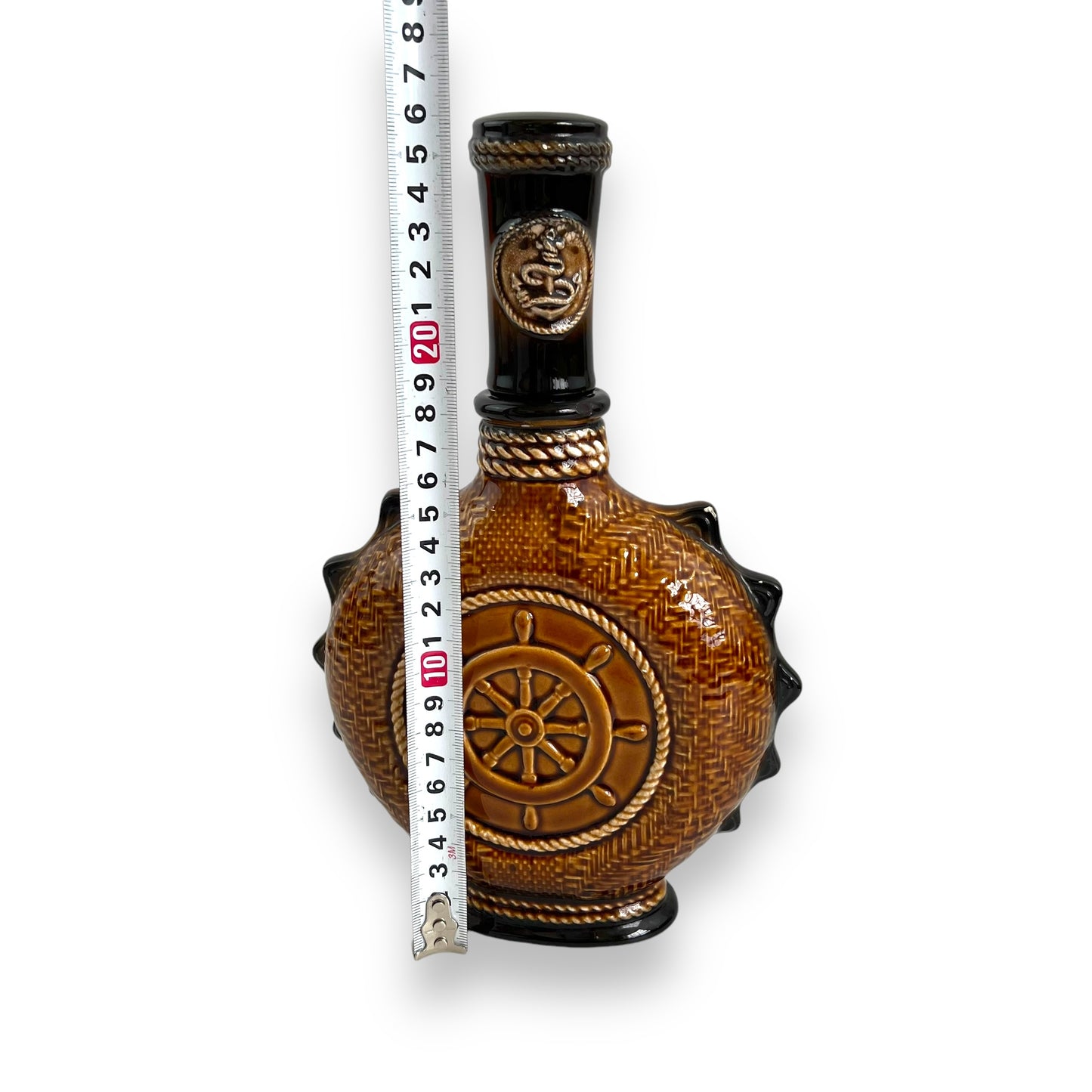 Brown Ceramic Decanter with Ship and wheel design.