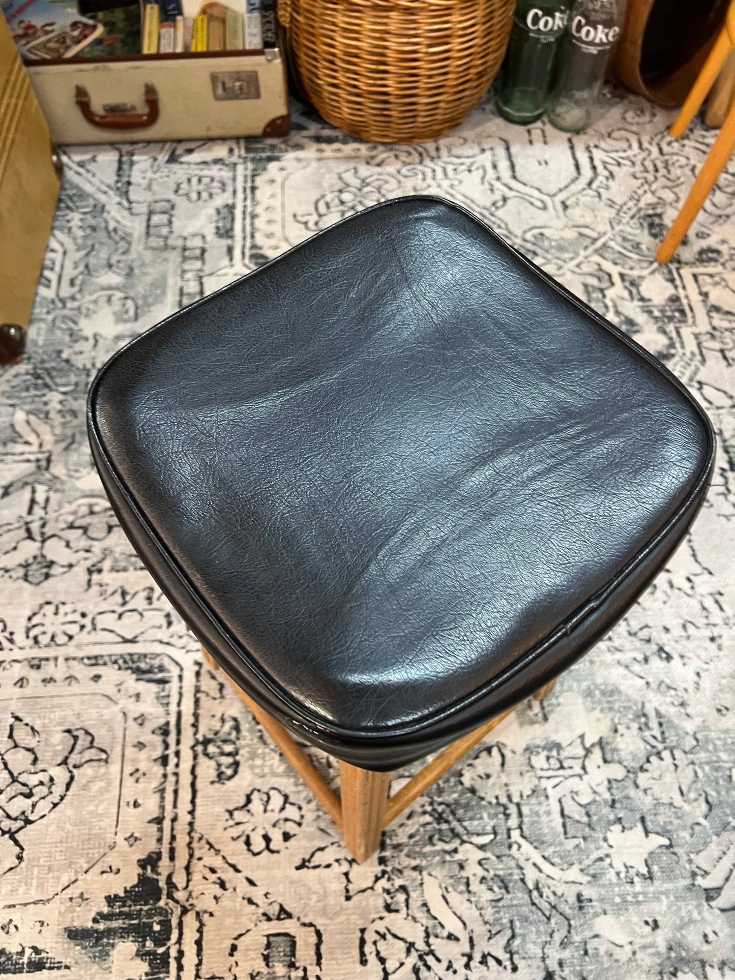 Wooden stool with black top
