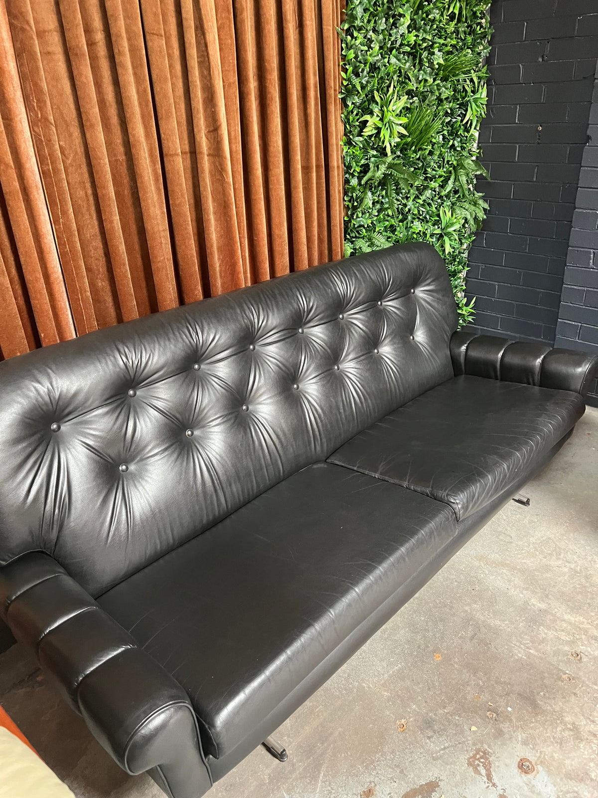 Black Button-Tufted Three-Seater Lounge with Chrome Legs