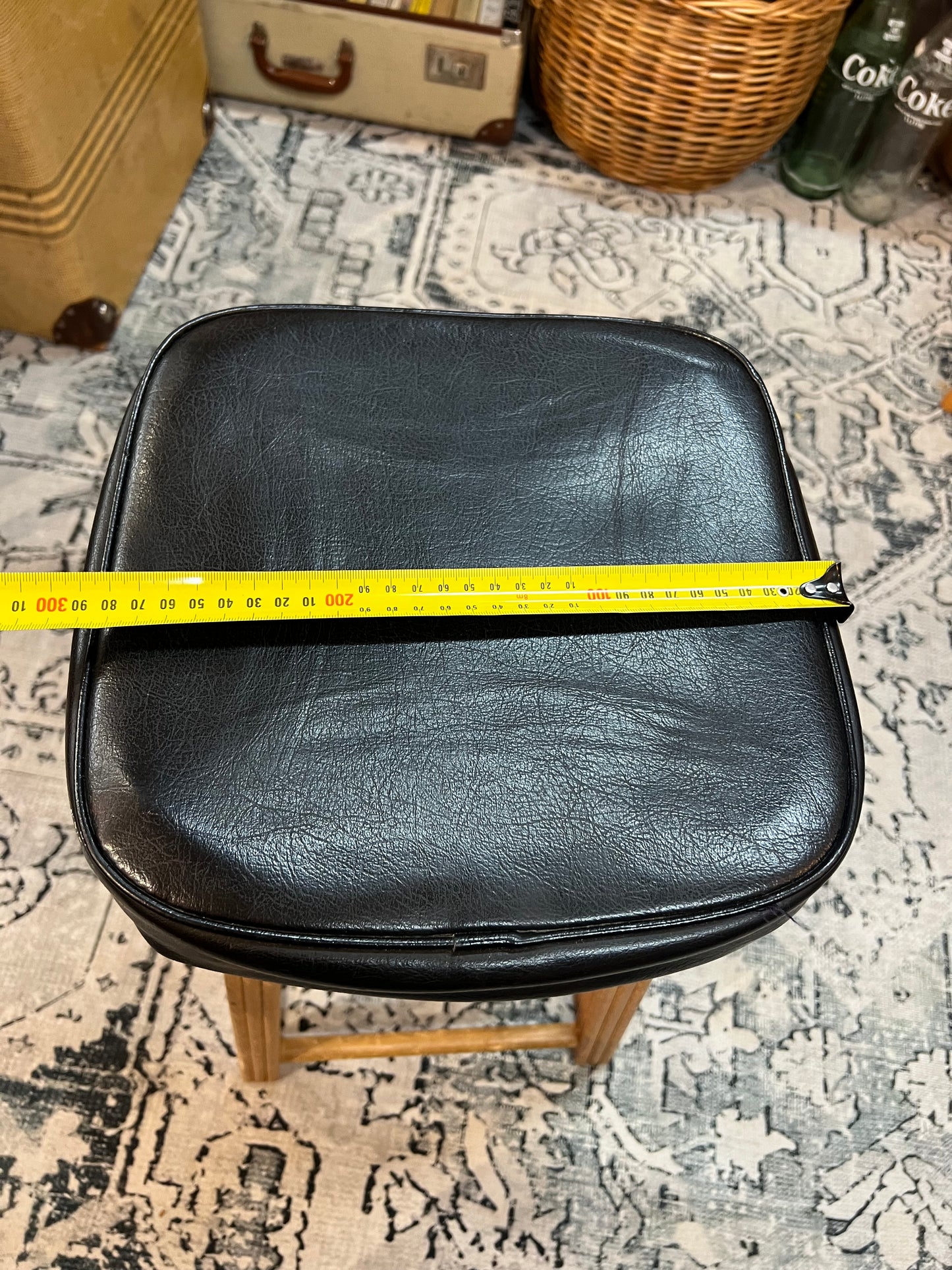 Wooden stool with black top