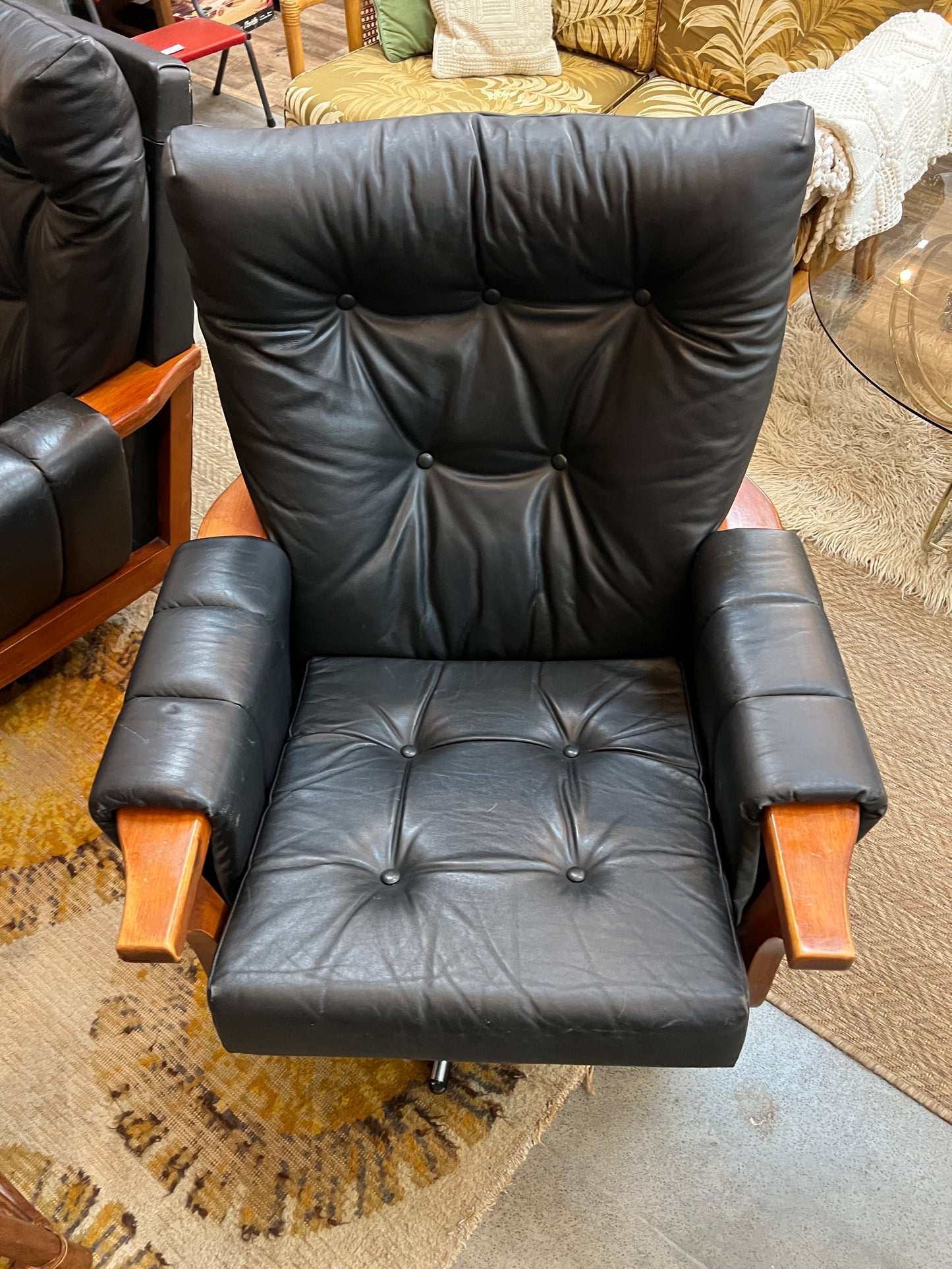 1. Mid-Century Black Leather Swivel Lounge Chair