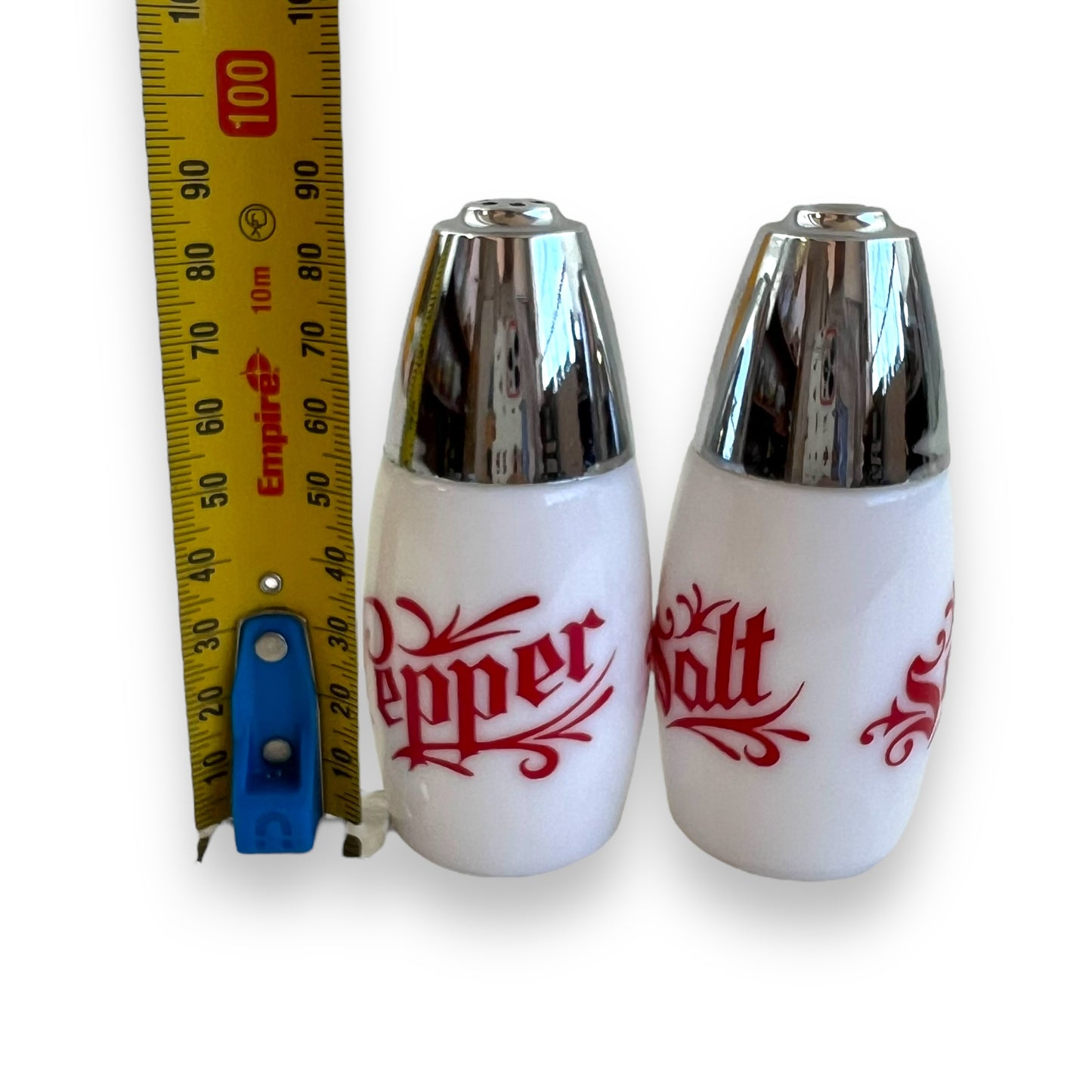 White with red writing and chrome top salt and pepper shaker set