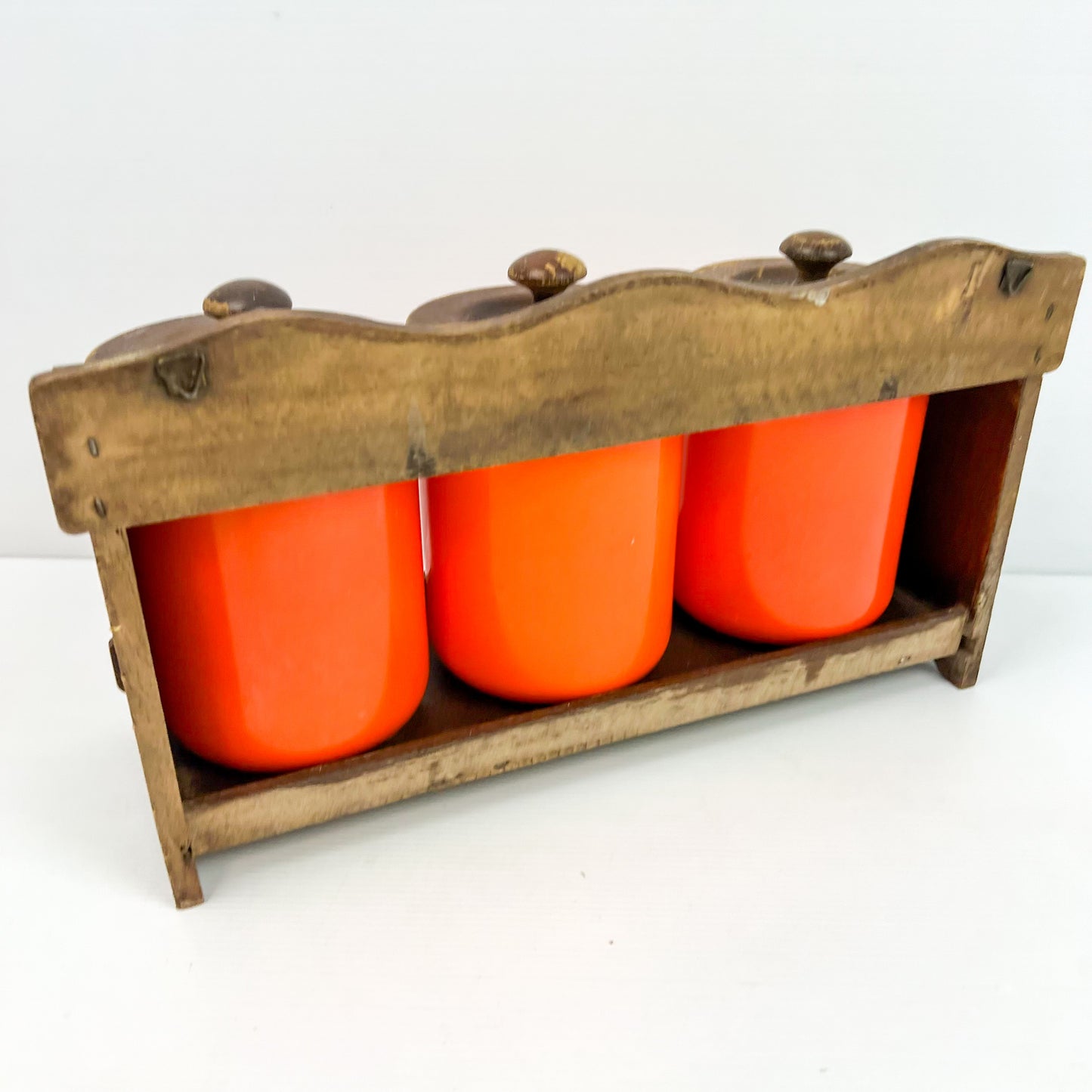 Orange Kitchen Storage Canister Jars with wooden lids and wooden hanging shelf