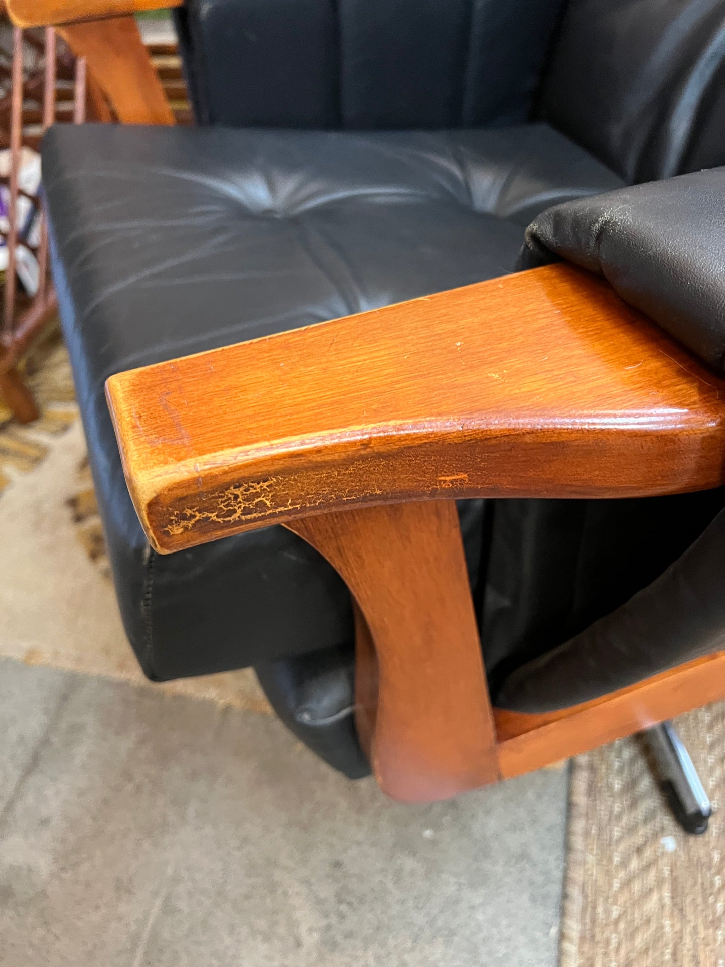 1. Mid-Century Black Leather Swivel Lounge Chair