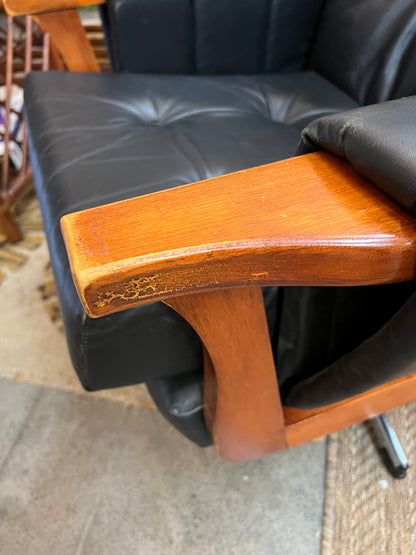 1. Mid-Century Black Leather Swivel Lounge Chair