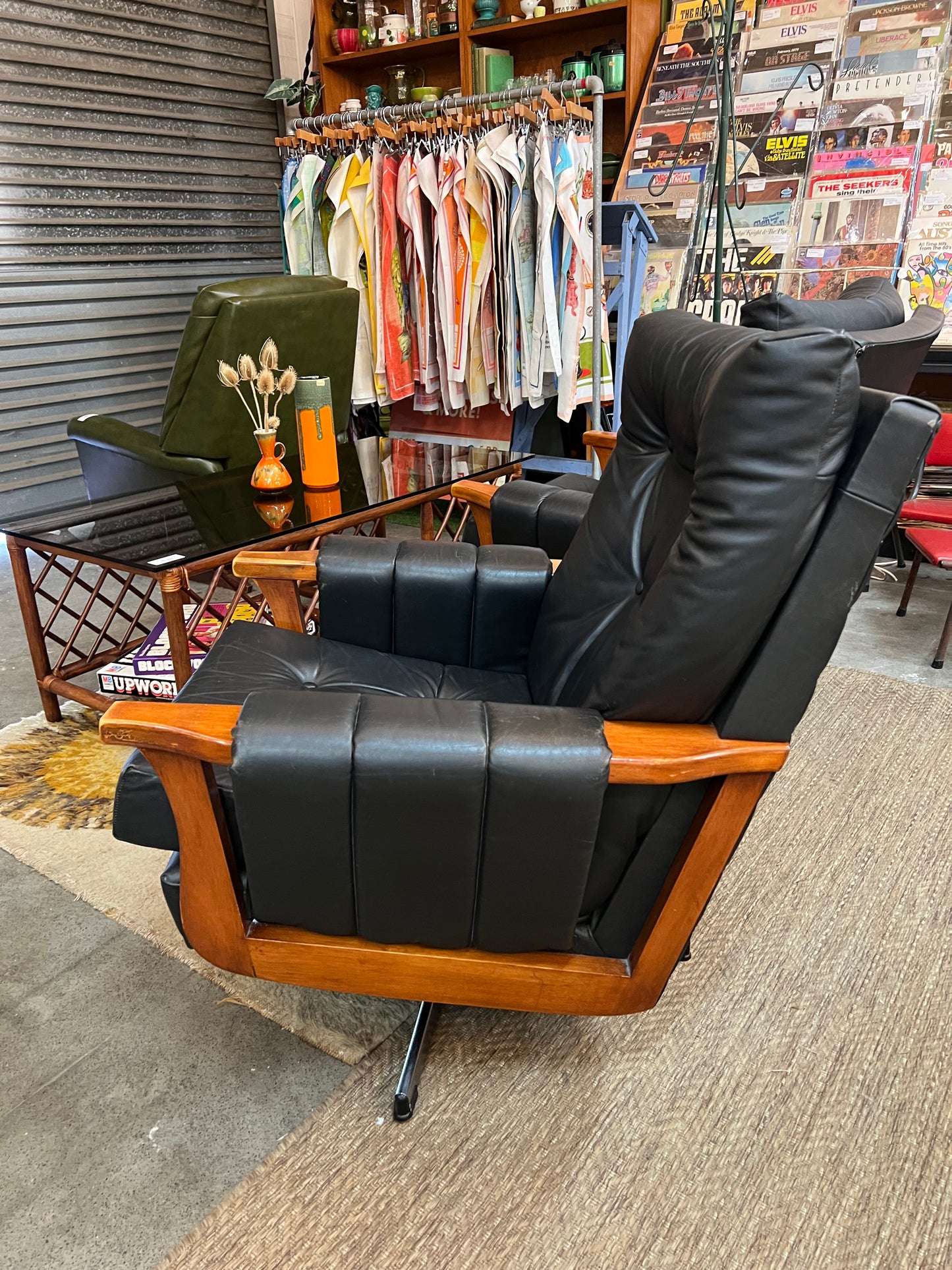 1. Mid-Century Black Leather Swivel Lounge Chair