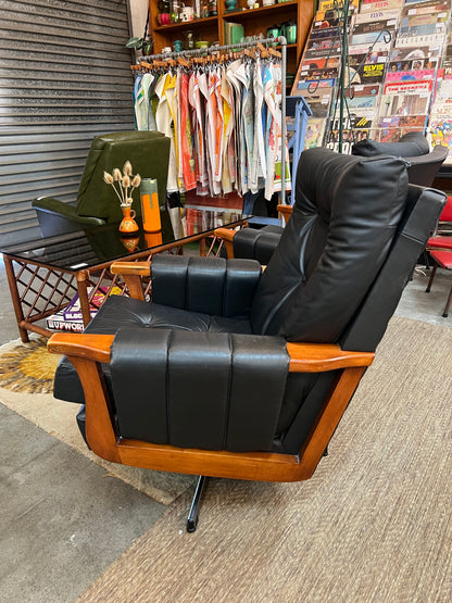 1. Mid-Century Black Leather Swivel Lounge Chair