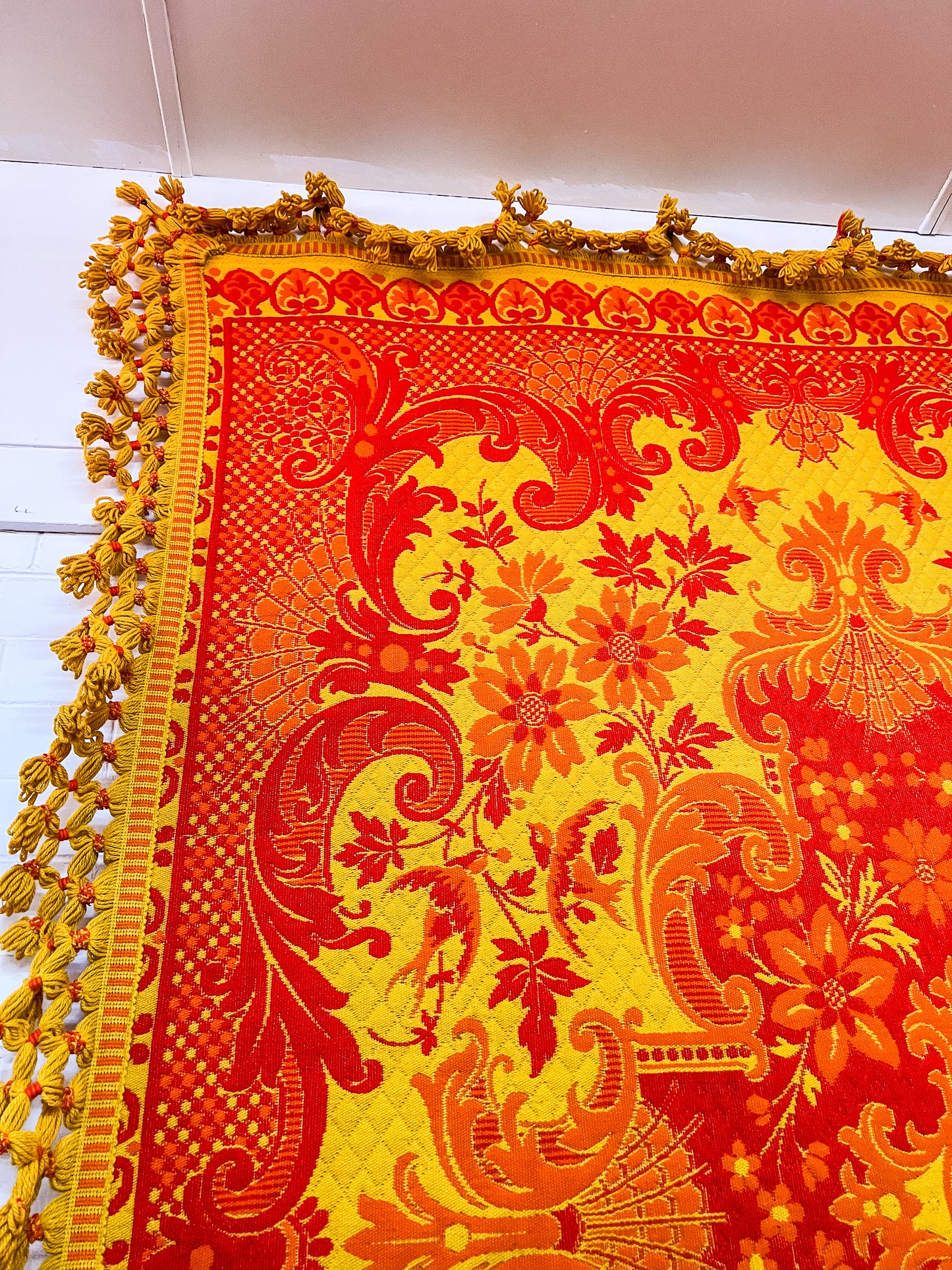 Large orange and yellow patterned wool rug