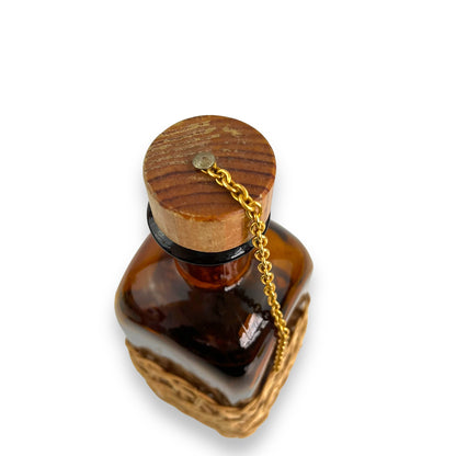 Amber glass decanter bottle with cane base and cork stopper