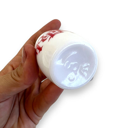 White with red writing and chrome top salt and pepper shaker set
